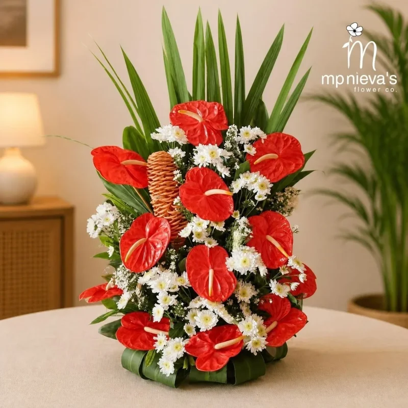 Devotion memorial arrangement with red anthuriums and white chrysanthemums by MP Nieva's Flower Shop