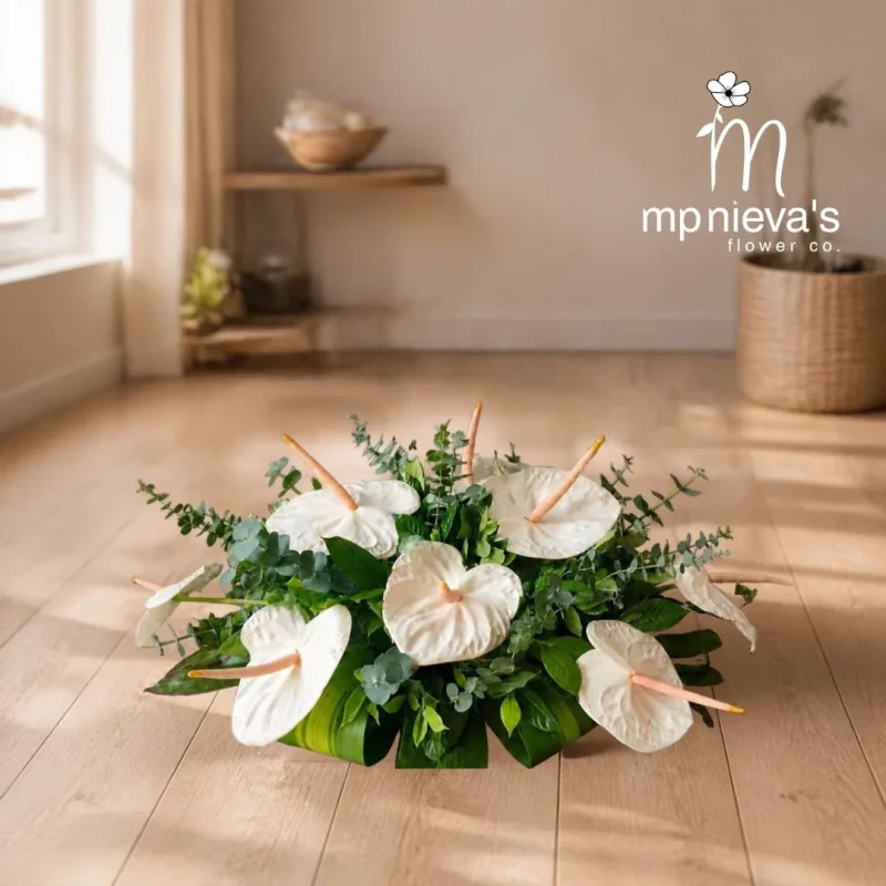 Purity small memorial arrangement with white anthuriums and eucalyptus by MP Nieva's Flower Shop