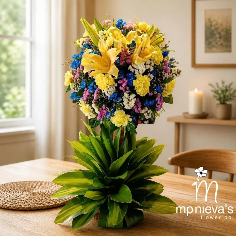 Radiance premium flower topiary with yellow lilies and blue accents by MP Nieva's Flower Shop