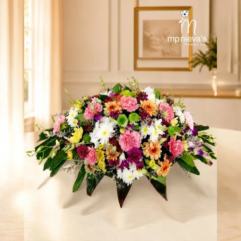 Serenity memorial spray with pink carnations, white chrysanthemums and purple orchids by MP Nieva's Flower Shop
